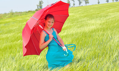 Image showing teenage girl with red umbrella in wheat field 