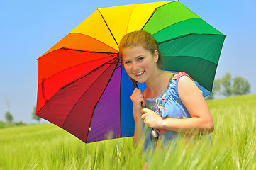 Image showing teenage girl with umbrella in wheat field