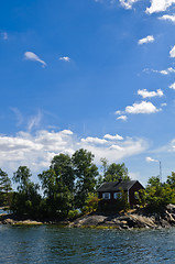 Image showing Swedish red cottage on a small island