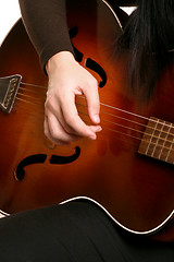 Image showing Playing strumming a guitar