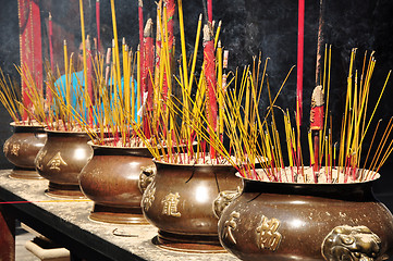 Image showing Incense or joss sticks burning in jars