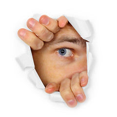 Image showing Man watches through a hole