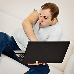 Image showing Comic man plays on a laptop