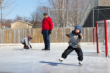 Image showing Family at a skating rink