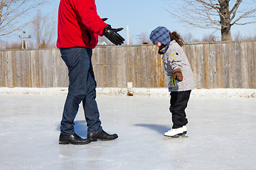 Image showing Father teaching daughter how to ice skate