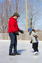 Image showing Father teaching daughter how to ice skate