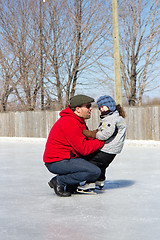 Image showing Father teaching daughter how to ice skate