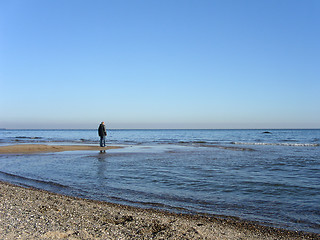 Image showing Lone person staring out to sea