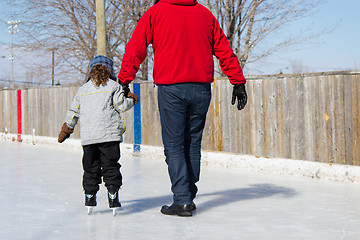 Image showing Father teaching daughter how to ice skate