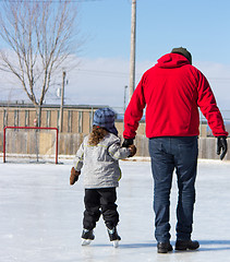 Image showing Father teaching daughter how to ice skate