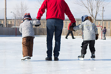 Image showing Family having fun at the skating rink