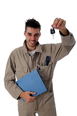 Image showing Friendly mechanic holding up car keys