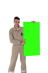 Image showing Craftsman holding a blank green board