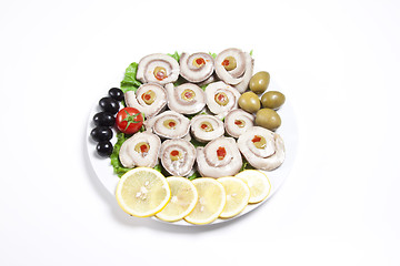 Image showing fish slices served with tomato and olives, and lemon