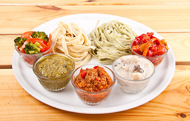 Image showing two italian tagliatelles and five various condiments