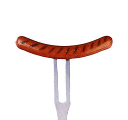 Image showing close up of sausage and fork on white