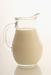 Image showing Glass jug with milk on white