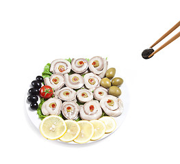 Image showing fish slices served with tomato and olives, and lemon