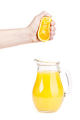 Image showing orange juice pouring into glass isolated on white