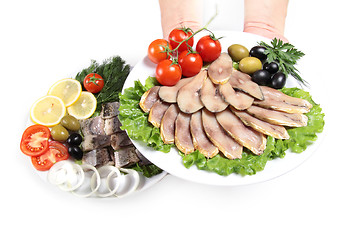 Image showing human hand with plate and slices fish