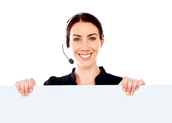 Image showing Attractive help-desk female holding blank placard