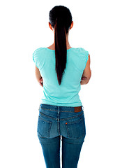 Image showing Beautiful young woman looking at wall. Rear view