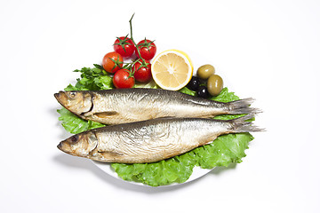 Image showing Smoked sprat-appetizing snack with tomato and lemon