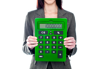 Image showing Business woman holding calculator. Focus on calculator