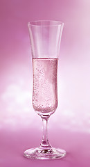 Image showing a glass  of champagne on pink background