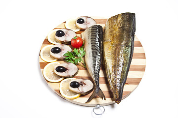 Image showing Dish with the cut smoked mackerel on wooden plate