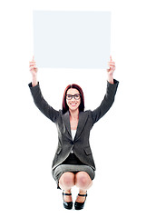 Image showing Seated corporate lady showing billboard