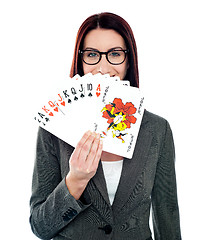 Image showing Corporate lady hiding her smile with playing cards