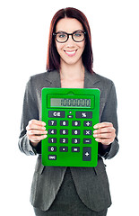 Image showing Business woman with a calculator