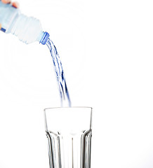 Image showing pouring water on glass on white background