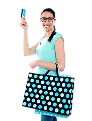 Image showing Attractive woman holding cerdit-card with shopping bags