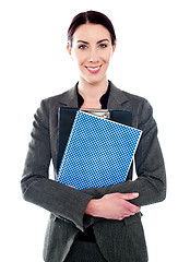 Image showing Corporate lady posing with clipboard and notepad