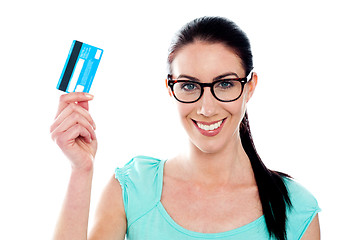 Image showing Portrait of young smiling woman holding credit card