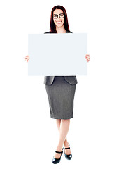 Image showing Portrait of a business lady holding a blank billboard