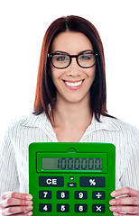 Image showing Smiling corporate lady showing green calculator