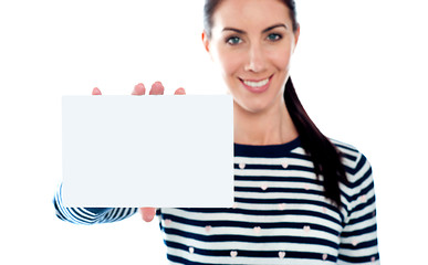Image showing Beautiful girl holding blank card. Copyspace