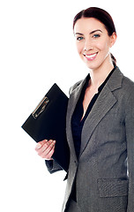 Image showing Smiling female secretary holding clipboard