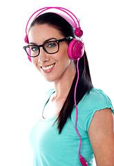 Image showing Pretty girl tuned into listening music via headphones