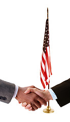 Image showing hand shake and American flag