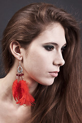 Image showing Young pretty girl with red earrings