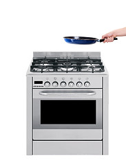 Image showing Hand and frying pan with gas-stove