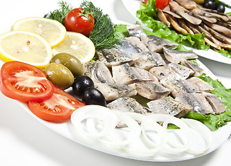 Image showing fish slices served with tomato and olives