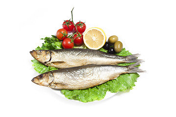 Image showing Smoked sprat-appetizing snack with tomato and lemon