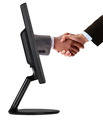 Image showing Businessmen shaking hands out of TV screen