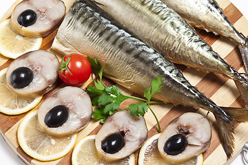 Image showing Dish with the cut smoked mackerel with olives