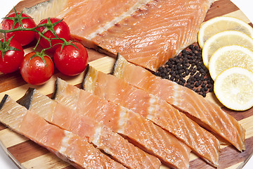 Image showing close-up of smoked salmon  with tomato and lemon